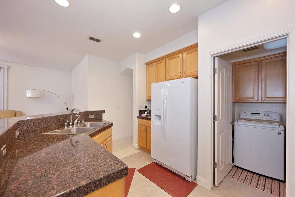 3930 Riley Anton Way Rancho Cordova, CA 95742 - Photo 21 of 45 a kitchen with stainless steel appliances granite countertop a refrigerator and a sink