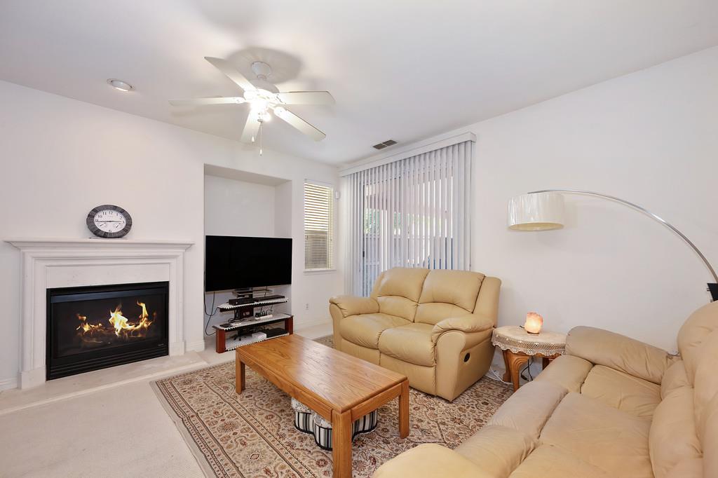 3930 Riley Anton Way Rancho Cordova, CA 95742 - Photo 23 of 45 a living room with furniture and a fireplace