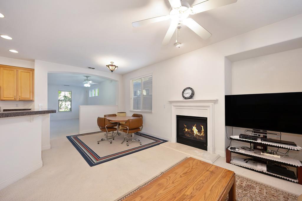 3930 Riley Anton Way Rancho Cordova, CA 95742 - Photo 26 of 45 a living room with furniture a flat screen tv and a fireplace
