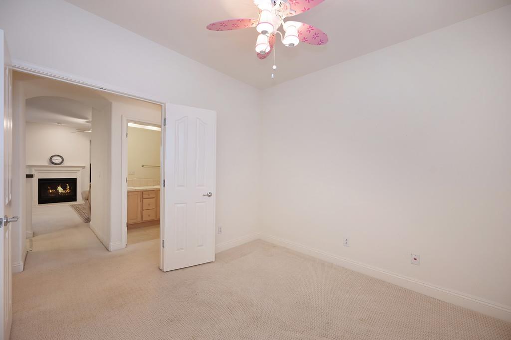 3930 Riley Anton Way Rancho Cordova, CA 95742 - Photo 28 of 45 an empty room with a chandelier fan and a bathroom