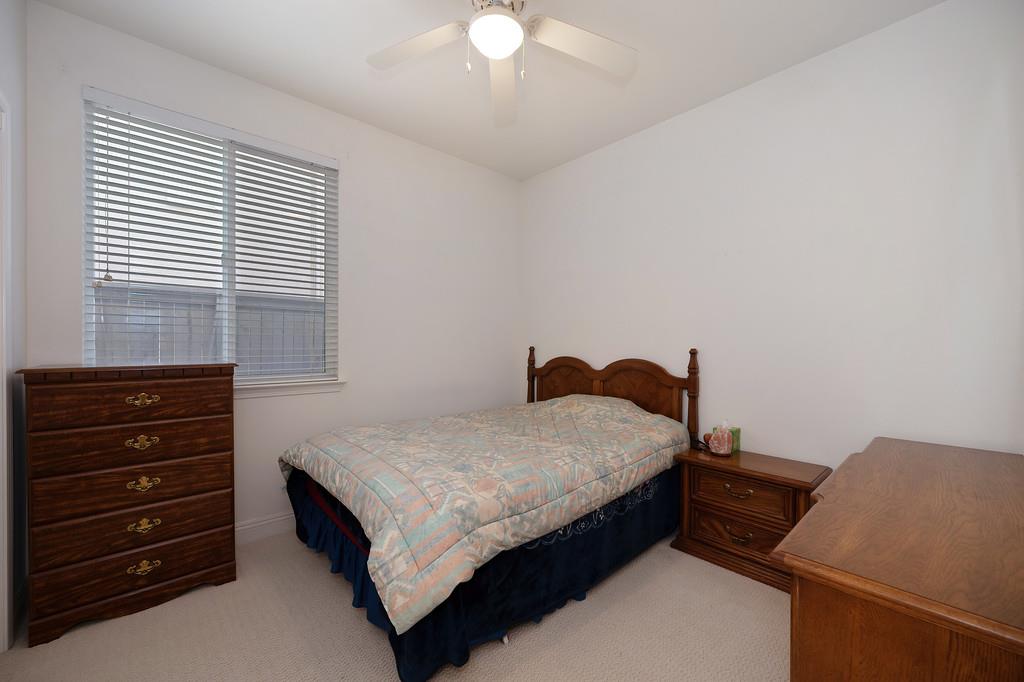 3930 Riley Anton Way Rancho Cordova, CA 95742 - Photo 30 of 45 a bedroom with a bed and a chandelier