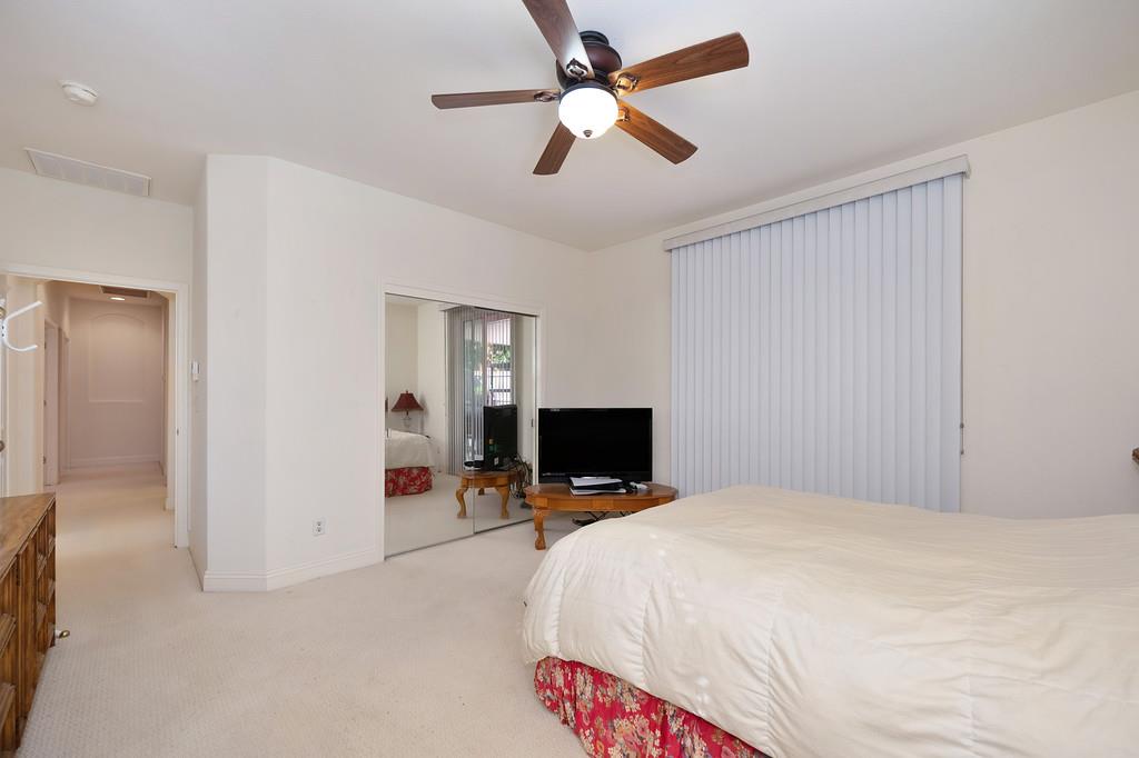 3930 Riley Anton Way Rancho Cordova, CA 95742 - Photo 34 of 45 a bedroom with a bed and a chandelier