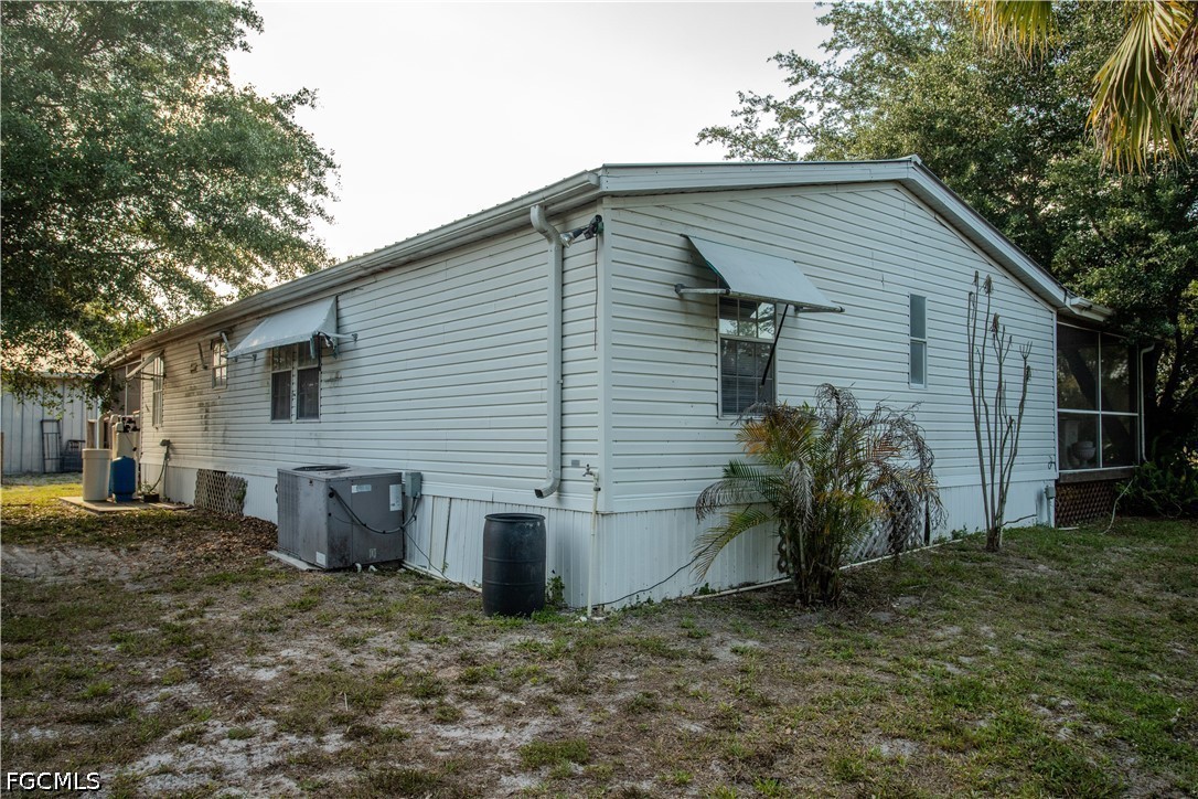3880 Packinghouse Road Alva, FL 33920 - Photo 17 of 29 a view of a house with backyard and a tree