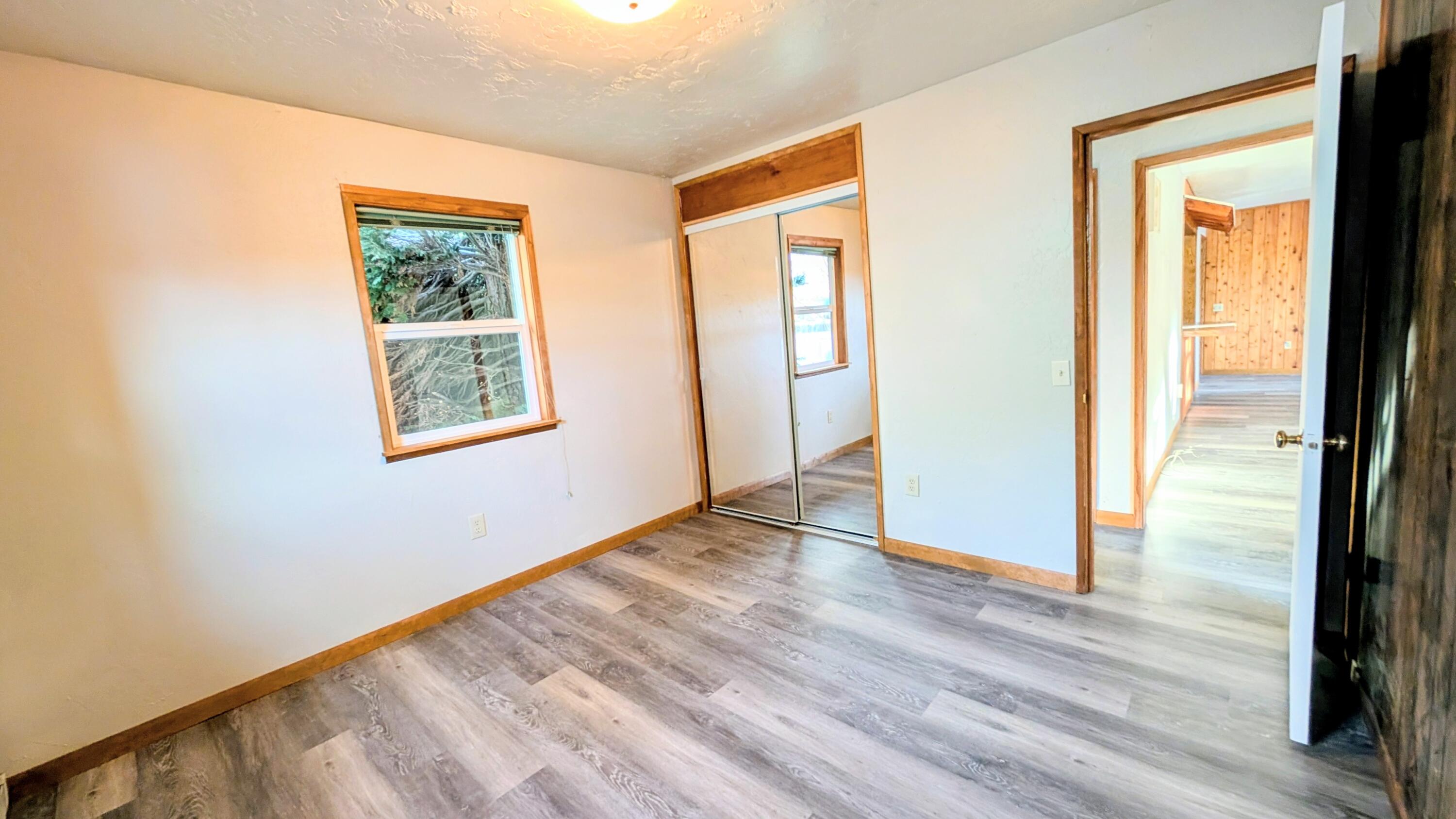 32550 Rivers Drive Chiloquin, OR 97624 - Photo 13 of 24 a view of an empty room with wooden floor and a window