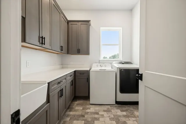 an aerial view of a house with a yard and a lake view