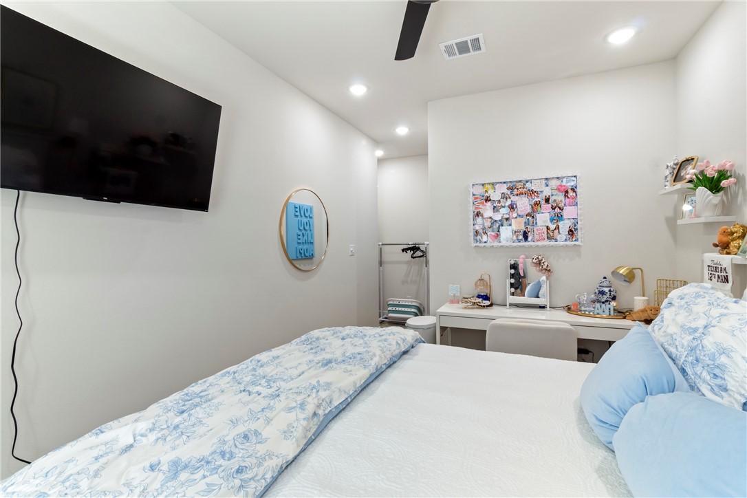 4078 Gunner Trail College Station, TX 77845 - Photo 12 of 33 a bedroom with a large bed and a flat screen tv