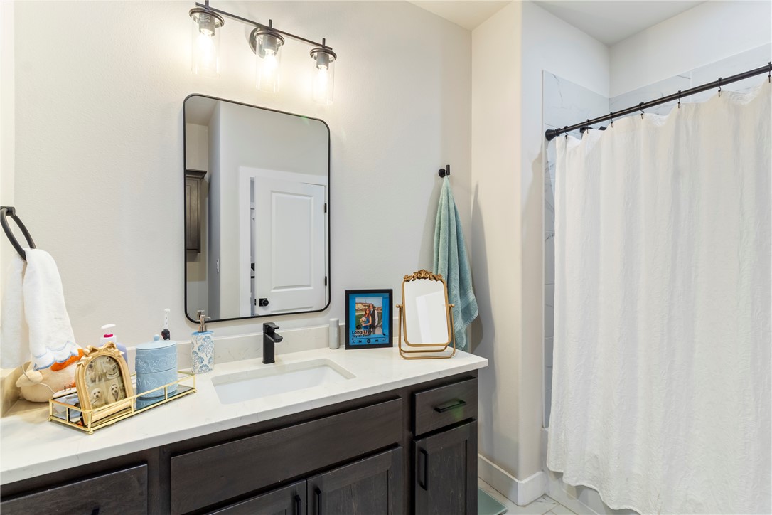 4078 Gunner Trail College Station, TX 77845 - Photo 13 of 33 a bathroom with a double vanity sink and a mirror