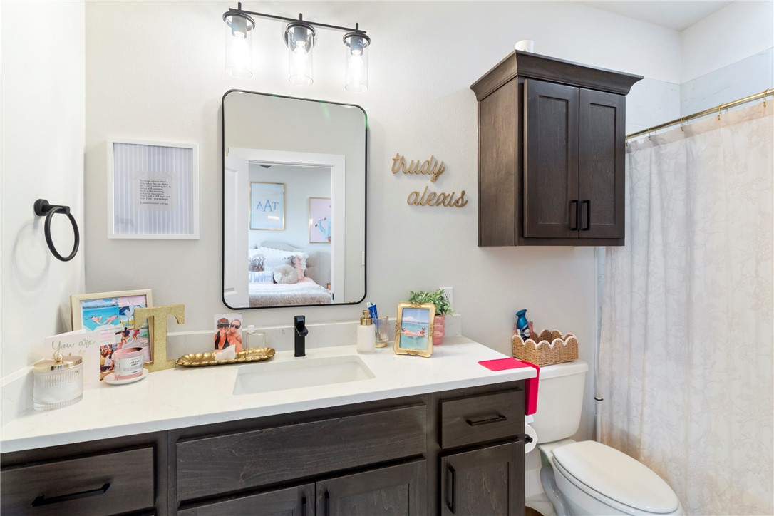 4078 Gunner Trail College Station, TX 77845 - Photo 19 of 33 a bathroom with a sink vanity mirror and toilet