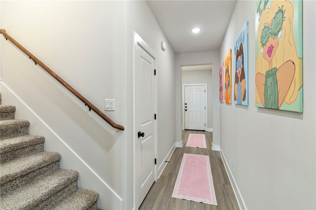 4078 Gunner Trail College Station, TX 77845 - Photo 2 of 33 a view of a hallway with wooden floor and staircase