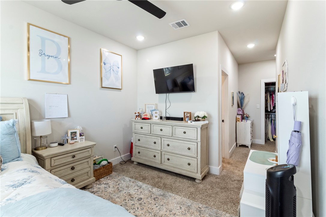 4078 Gunner Trail College Station, TX 77845 - Photo 21 of 33 a room with furniture a flat screen tv and a refrigerator