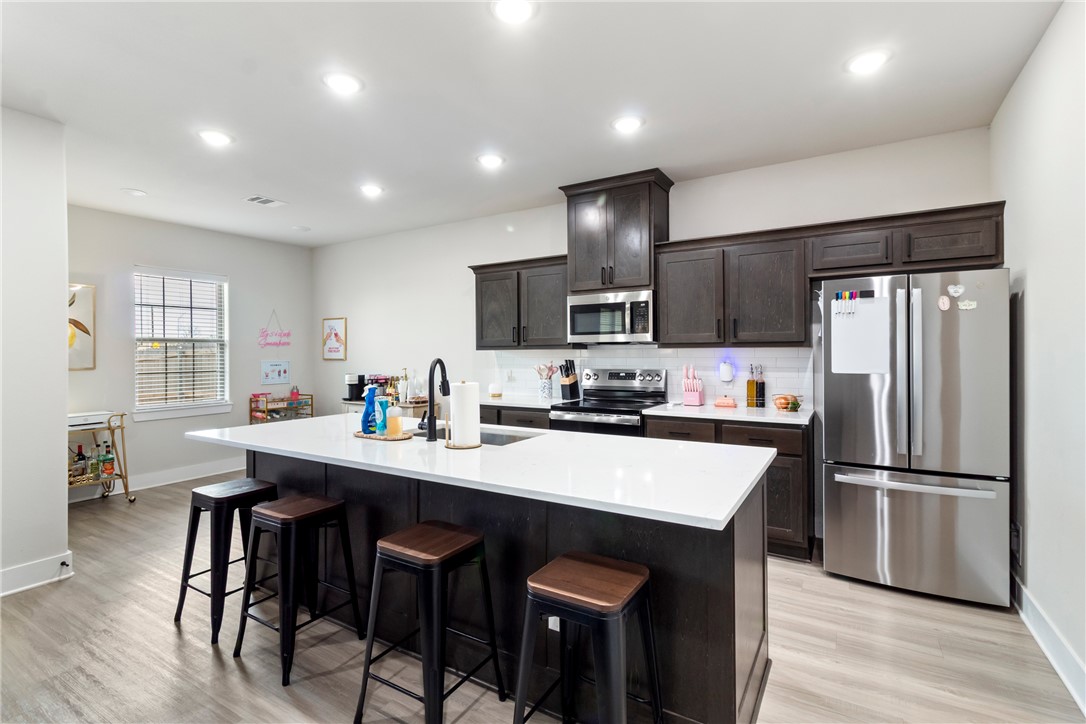 4078 Gunner Trail College Station, TX 77845 - Photo 6 of 33 a kitchen with refrigerator cabinets dining table and chairs