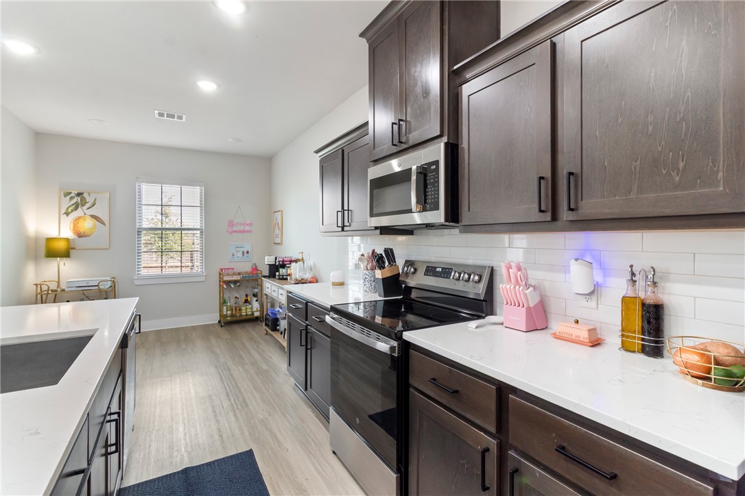 4078 Gunner Trail College Station, TX 77845 - Photo 7 of 33 a kitchen with a sink stove top oven and microwave