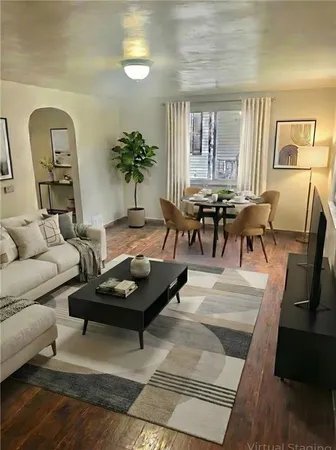 a living room with furniture and a potted plant