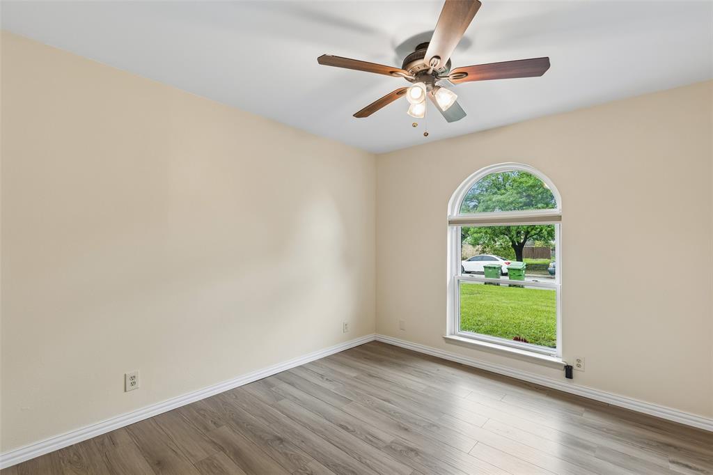 1548 Timbercreek Drive Howe, TX 75459 - Photo 13 of 24 an empty room with wooden floor fan and windows