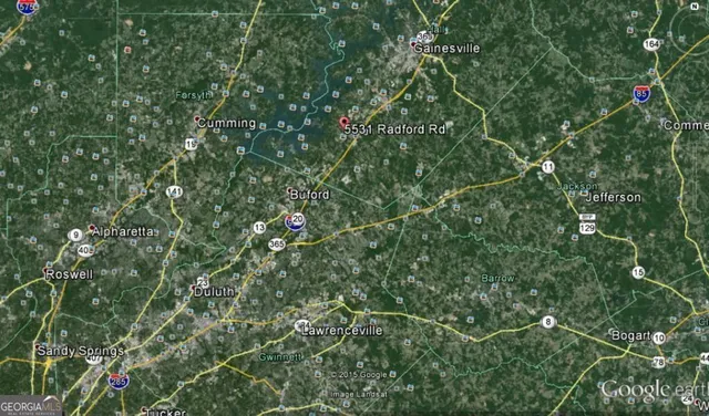 an aerial view of a house with table and chairs