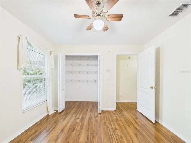 a view of a patio with table and chairs and wooden fence