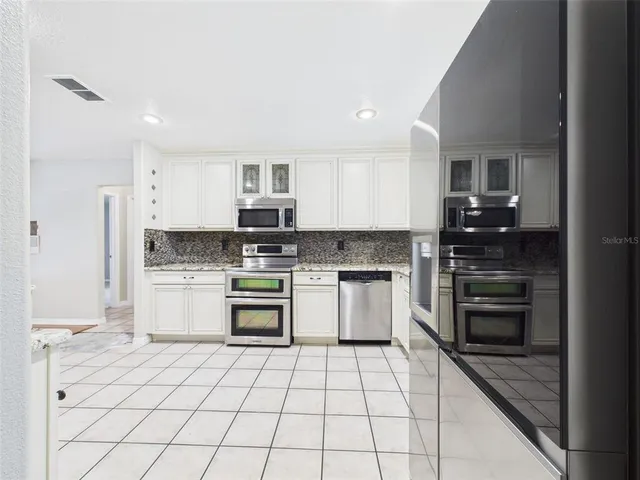 a view of a kitchen with a sink and a stove