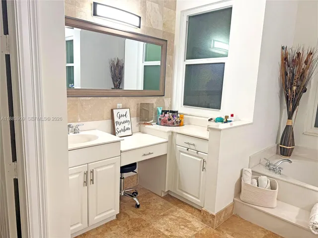 a utility room with cabinets washer and dryer
