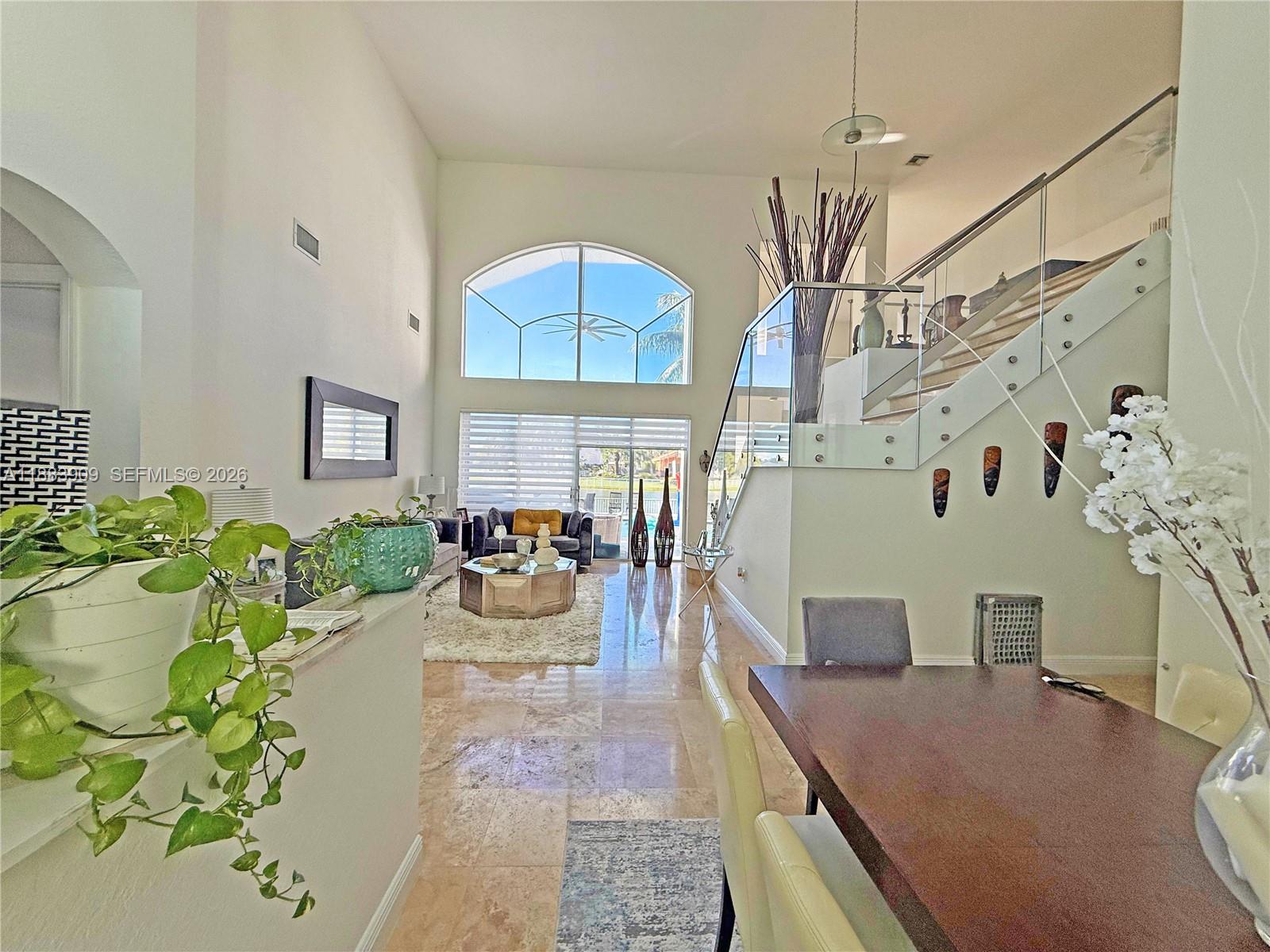 18560 Southwest 44th Street Miramar, FL 33029 - Photo 2 of 16 a dining room with furniture potted plants and wooden floor