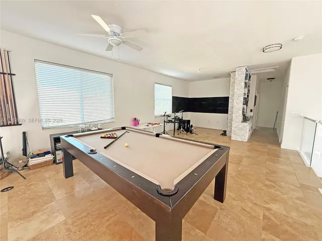 a room with pool table and flat screen tv