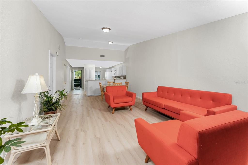 6800 Placida Road, Unit 228 Englewood, FL 34224 - Photo 13 of 45 a living room with furniture and a lamp
