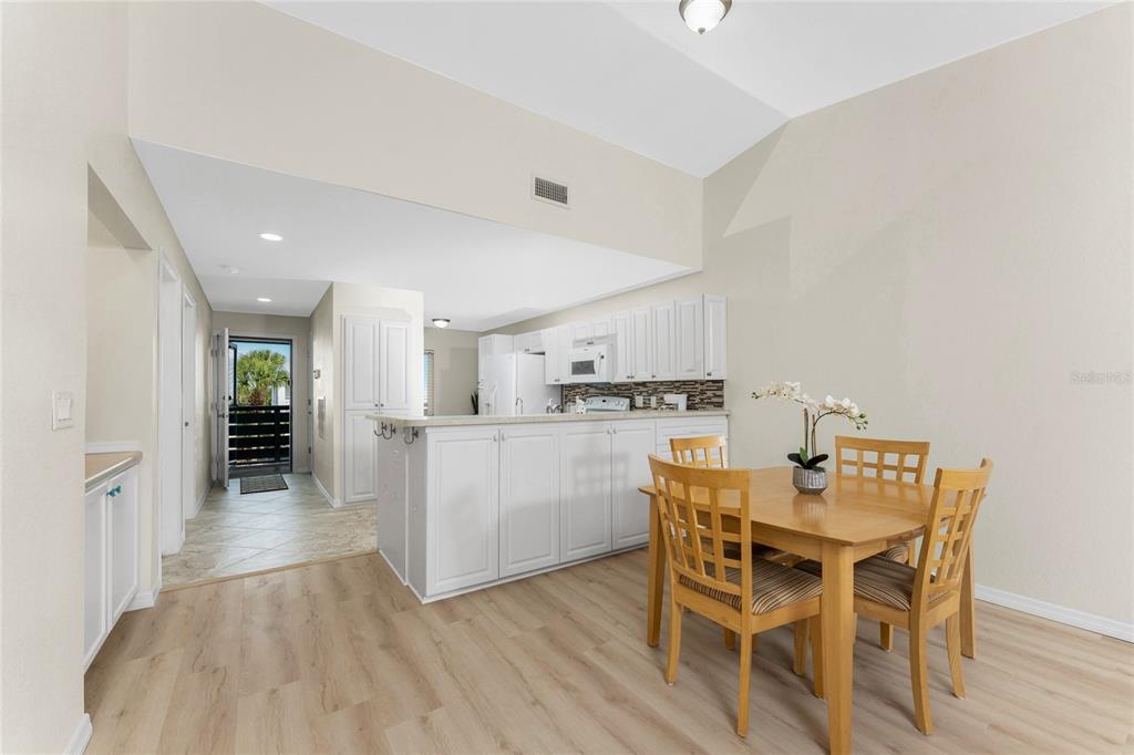 6800 Placida Road, Unit 228 Englewood, FL 34224 - Photo 14 of 45 a view of a dining room with furniture and wooden floor