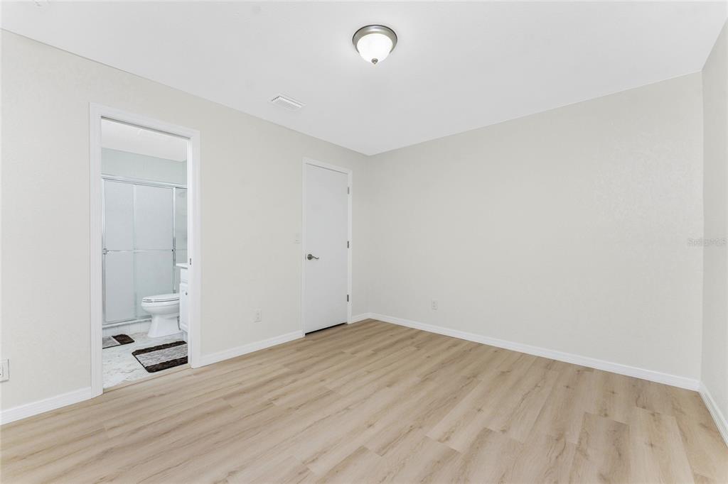 6800 Placida Road, Unit 228 Englewood, FL 34224 - Photo 16 of 45 an empty room with wooden floor and windows