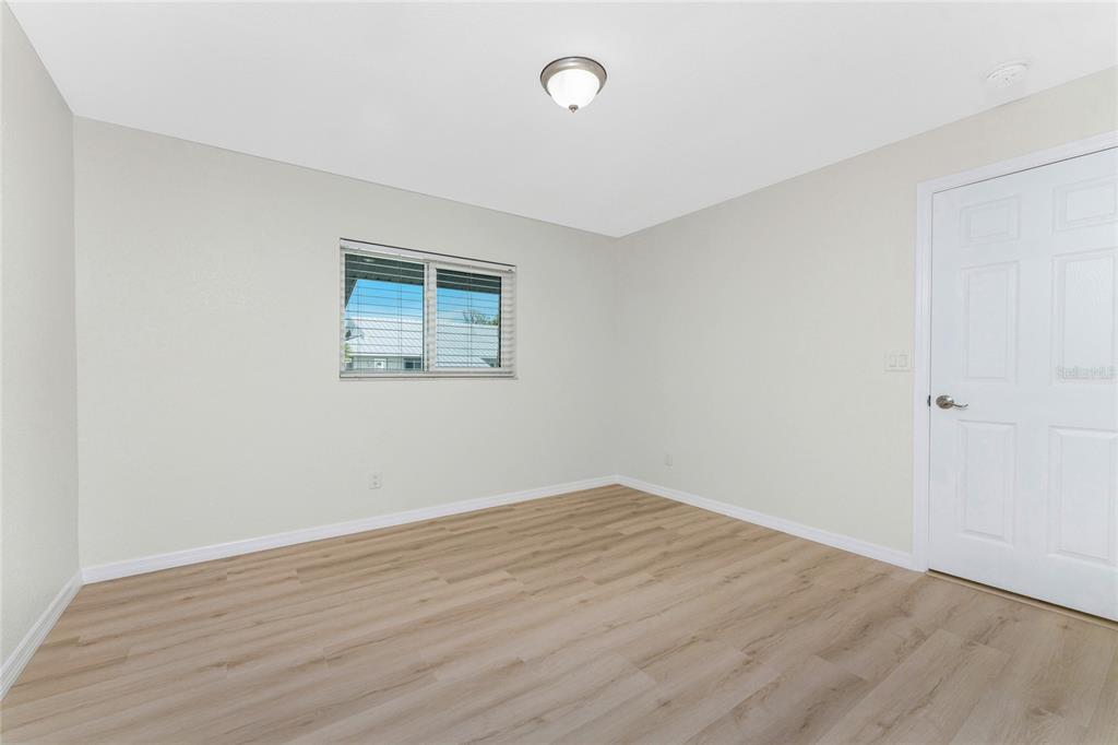 6800 Placida Road, Unit 228 Englewood, FL 34224 - Photo 17 of 45 wooden floor in an empty room with a window