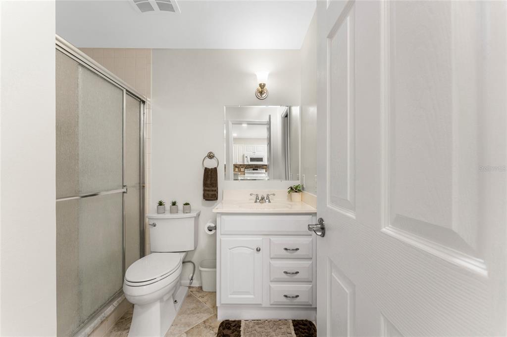 6800 Placida Road, Unit 228 Englewood, FL 34224 - Photo 19 of 45 a bathroom with a sink a toilet a mirror and shower