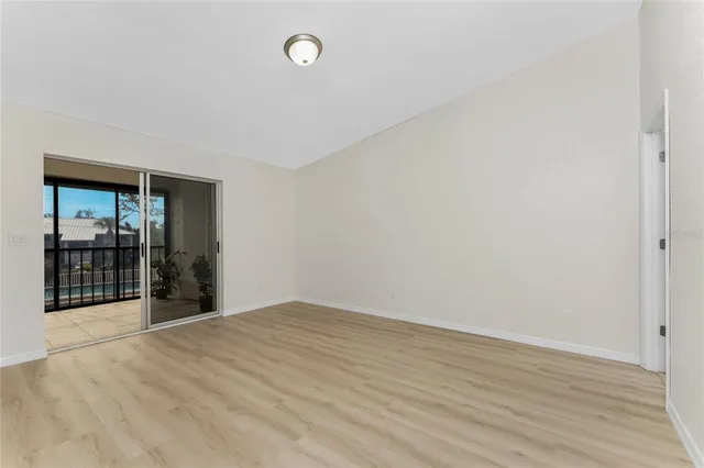a view of an empty room with wooden floor