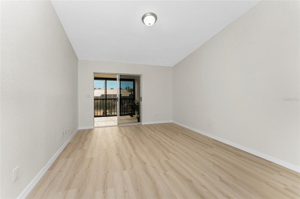 6800 Placida Road, Unit 228 Englewood, FL 34224 - Photo 22 of 45 wooden floor in an empty room with a window