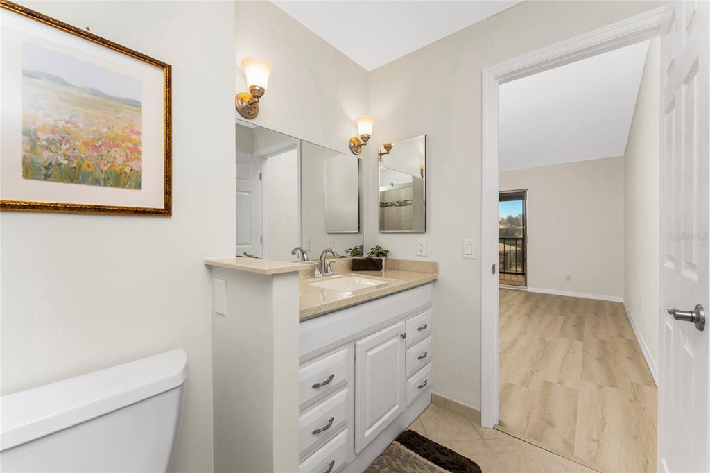 6800 Placida Road, Unit 228 Englewood, FL 34224 - Photo 26 of 45 a bathroom with a double vanity sink and a mirror