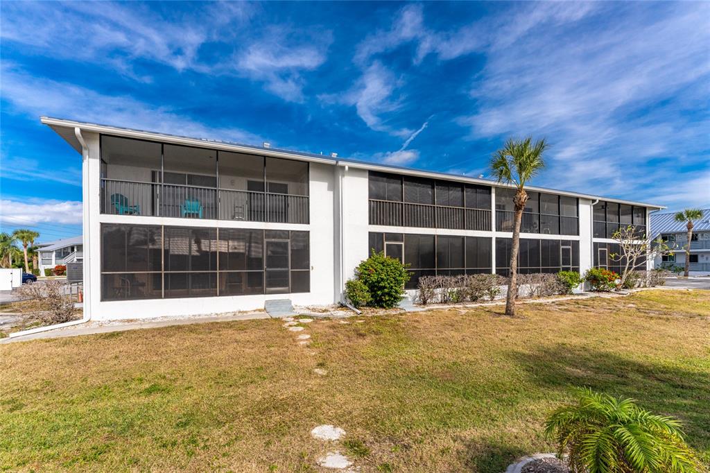 6800 Placida Road, Unit 228 Englewood, FL 34224 - Photo 34 of 45 a view of a house with a yard