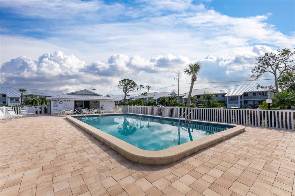 6800 Placida Road, Unit 228 Englewood, FL 34224 - Photo 36 of 45 a view of a swimming pool with a patio