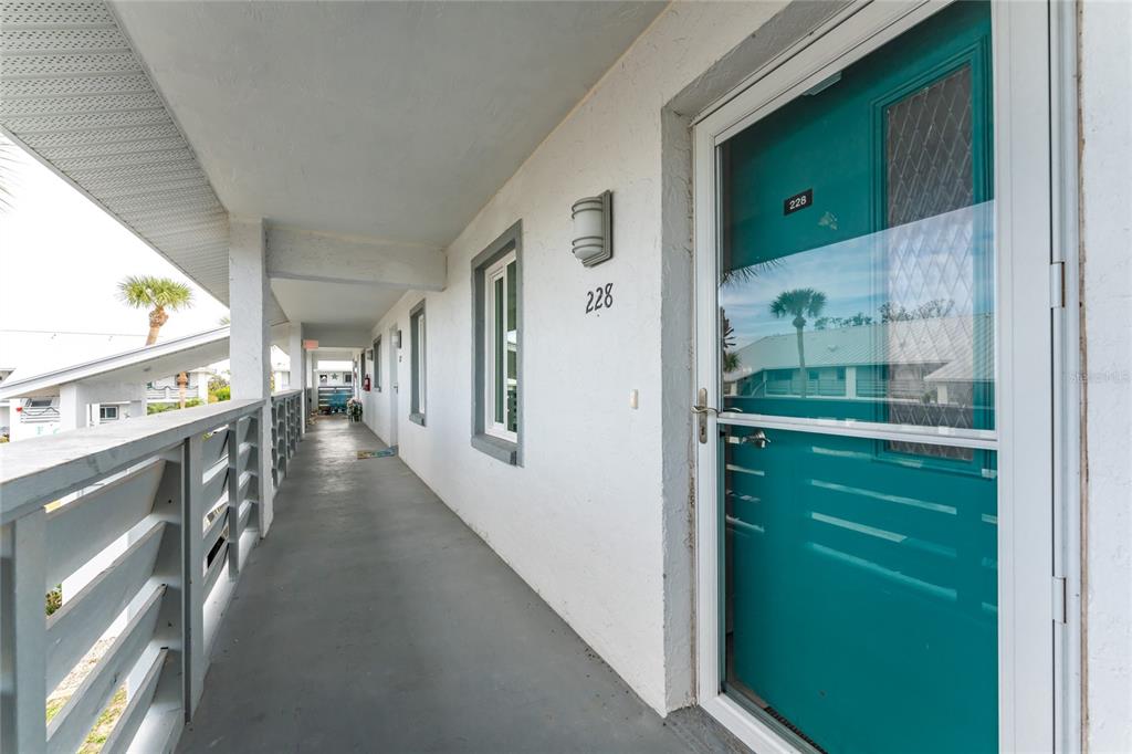 6800 Placida Road, Unit 228 Englewood, FL 34224 - Photo 6 of 45 a hallway with a washer and dryer