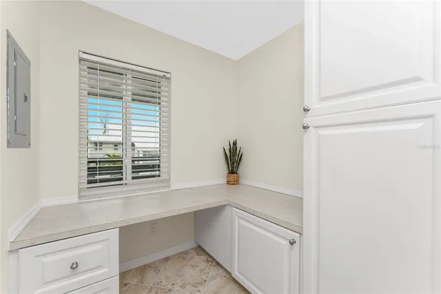 a room with a window and a potted plant