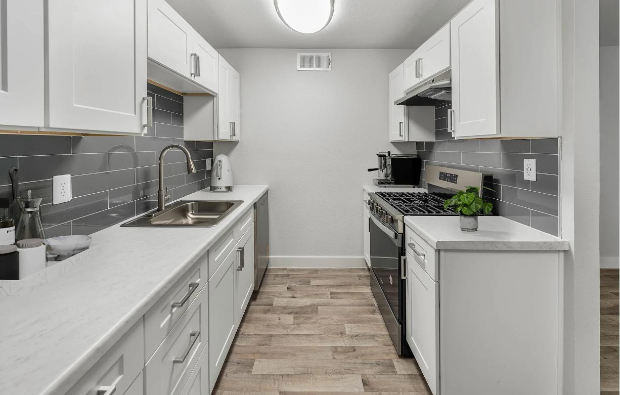 2025 West Indian School Road, Unit 1 Phoenix, AZ 85015 - Photo 4 of 12 a kitchen with a sink stove top oven and cabinets