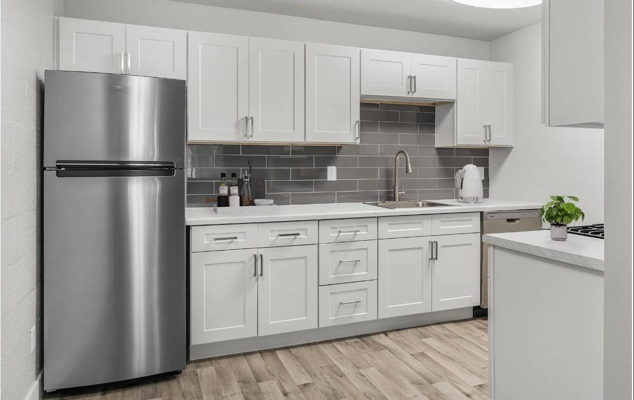 2025 West Indian School Road, Unit 1 Phoenix, AZ 85015 - Photo 5 of 12 a kitchen with appliances a refrigerator and a sink