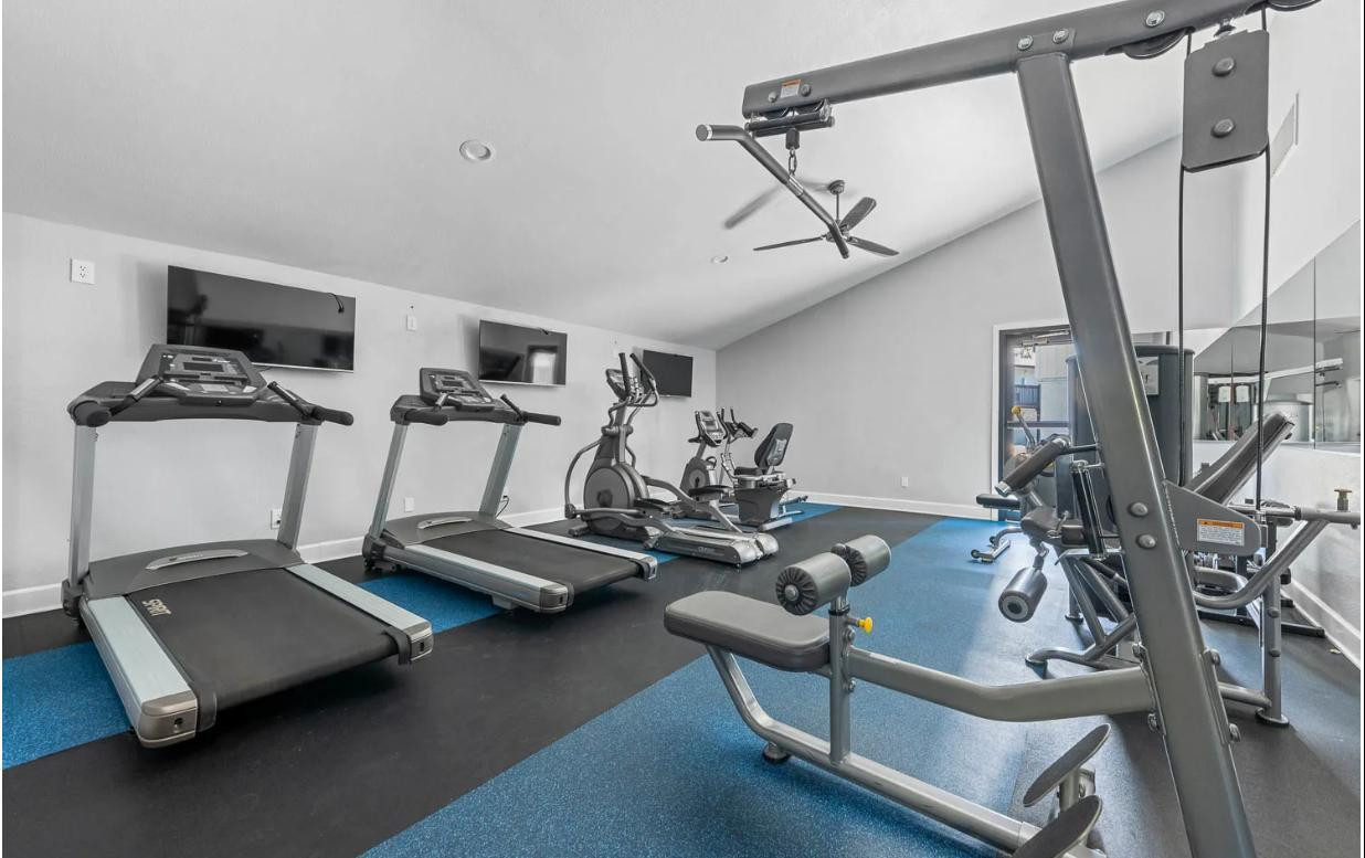 2025 West Indian School Road, Unit 1 Phoenix, AZ 85015 - Photo 10 of 12 a room with gym equipment and view of living room