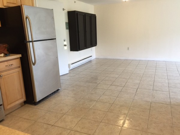 222 Stackpole Street, Unit 15 Lowell, MA 01852 - Photo 16 of 16 a view of a refrigerator in kitchen and an empty room