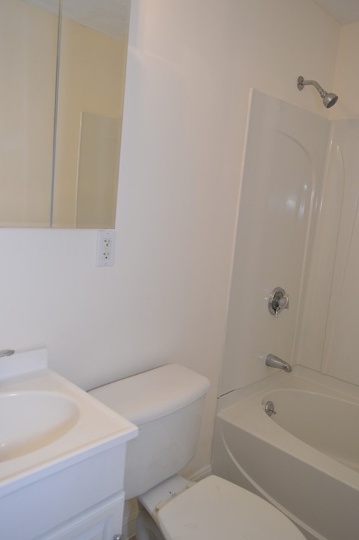 222 Stackpole Street, Unit 15 Lowell, MA 01852 - Photo 7 of 16 a bathroom with a bathtub and a toilet