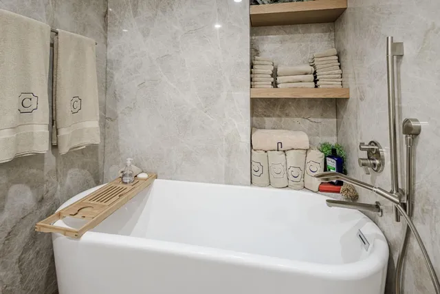 a bathroom with a tub and a shower