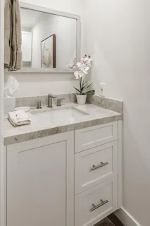 a bathroom with a sink vanity and a mirror