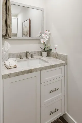 a bathroom with a sink vanity and a mirror