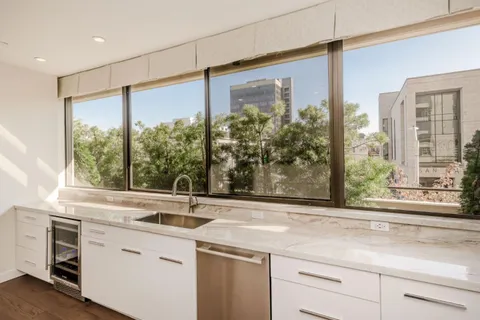 a view of a sink and a large mirror