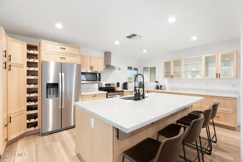 a bedroom with a large bed and a chandelier