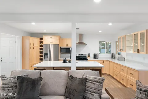 a view of a workspace with furniture and wooden floor