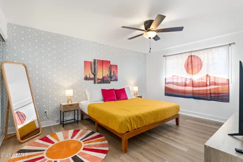 a bedroom with a bed and wooden floor