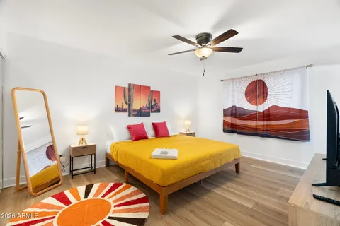 a bedroom with a bed and a flat screen tv