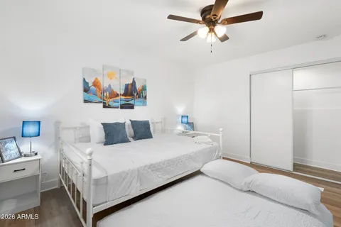 view of a hallway with wooden floor and a fireplace